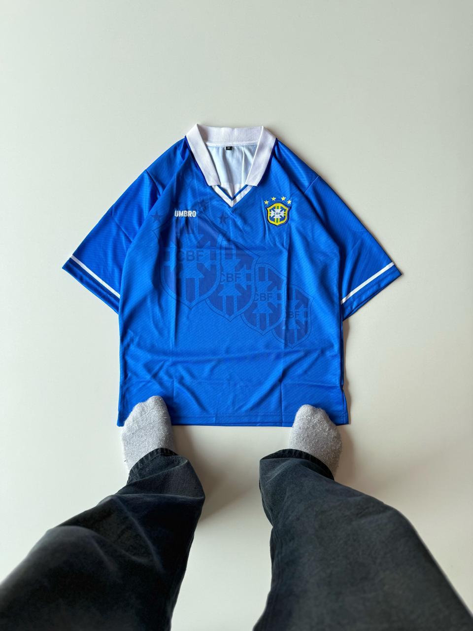 Front view of the retro Brazil 1994 World Cup away jersey in royal blue featuring a white overlap collar and sublimated CBF crest patterns at vamstore India.