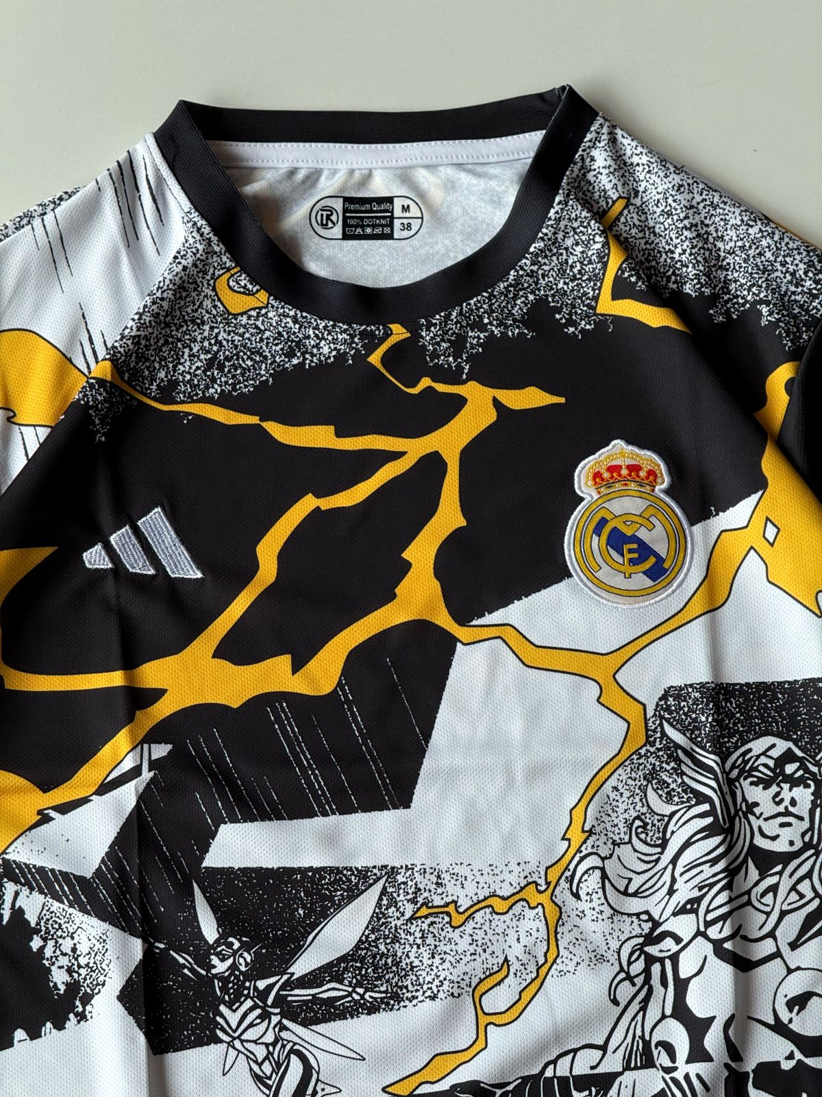 Close-up front view of the Real Madrid 2024 2025 special edition Marvel Avengers jersey highlighting the premium embroidered club crest and comic book Thor graphic layout at vamstore India.