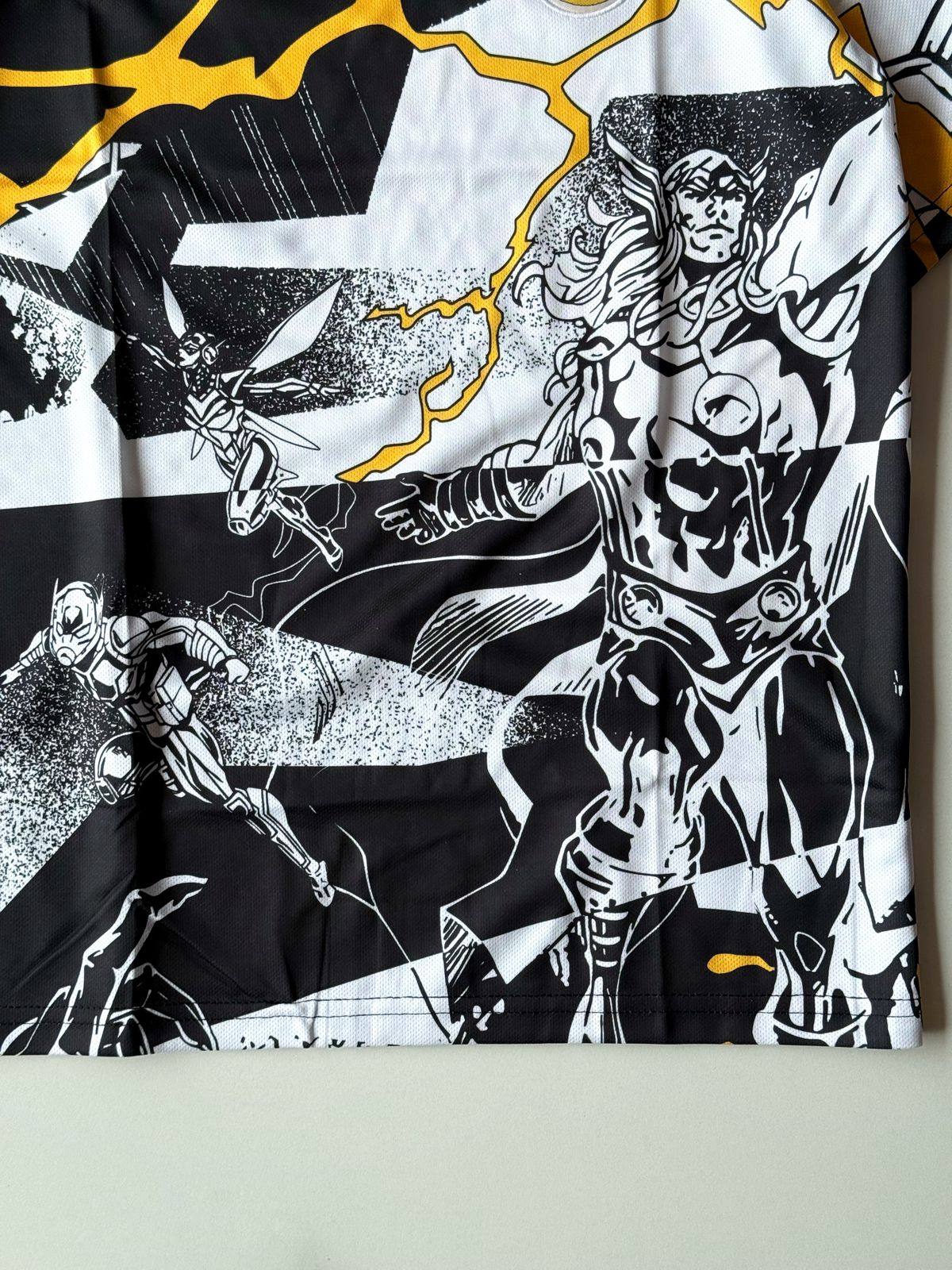 Lower front view of the Real Madrid 2024 2025 special edition Marvel Avengers jersey highlighting the comic book Iron Man sketch and yellow lightning patterns at vamstore India.