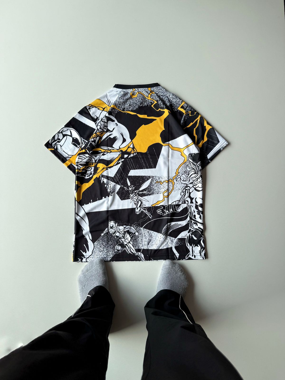 Back view of the Real Madrid 2024 2025 special edition Marvel Avengers jersey showcasing the full all-over comic book collage and yellow lightning design at vamstore India.