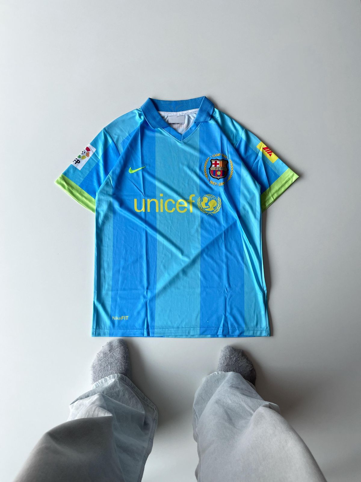 Barcelona 2006 2007 away jersey in vibrant light blue featuring textured vertical stripes and high density embroidered club crest at vamstore India.