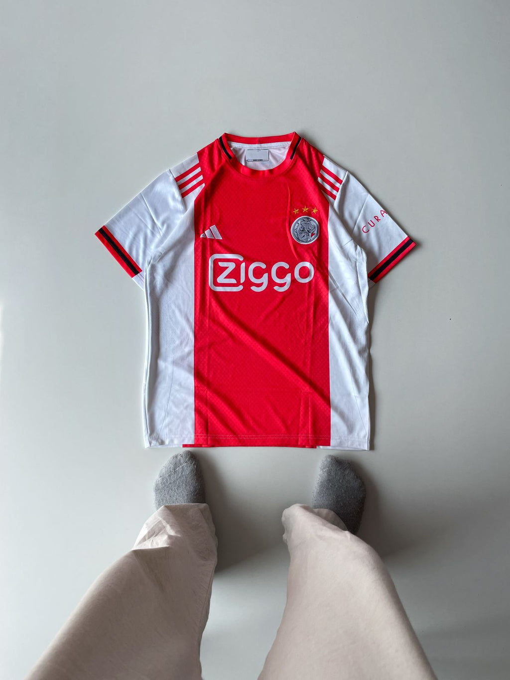 Ajax Amsterdam 2024 2025 home jersey featuring the iconic thick red vertical torso panel and premium embroidered club crest at vamstore India.