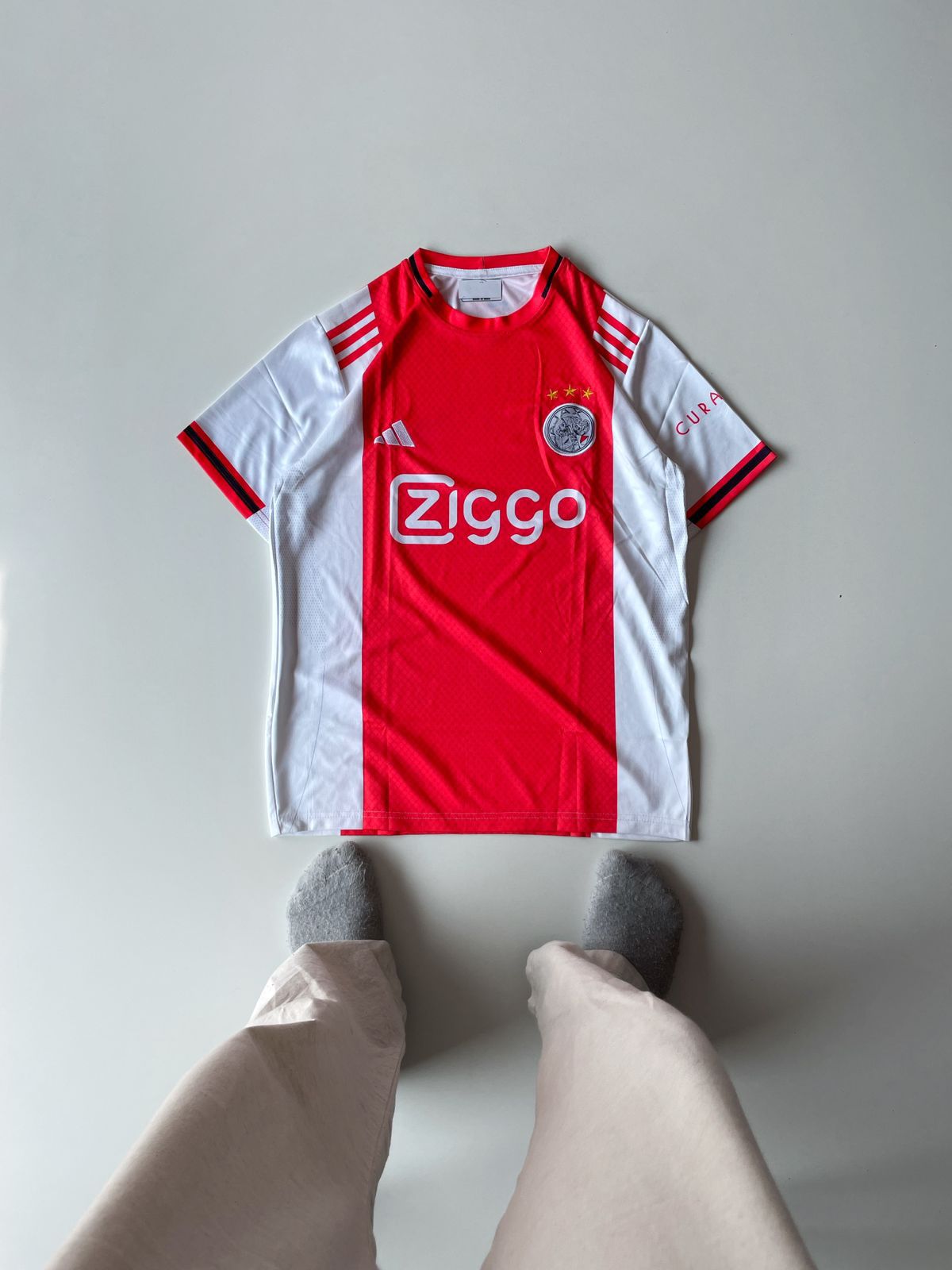 Ajax Amsterdam 2024 2025 home jersey featuring the iconic thick red vertical torso panel and premium embroidered club crest at vamstore India.